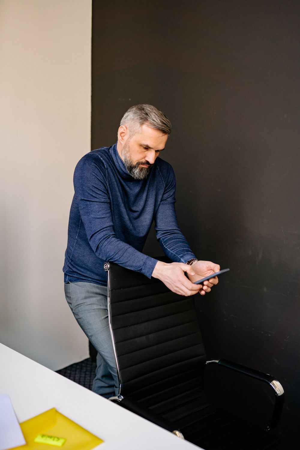 A self-employed professional reviewing his work on a tablet