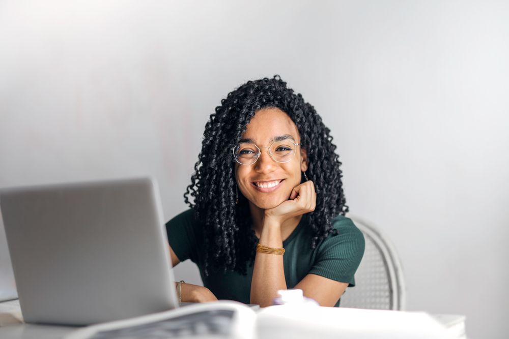 A smiling freelancer at her laptop