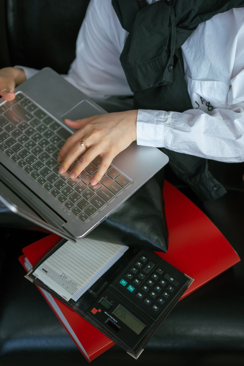 Recording financial information using a laptop and notebook