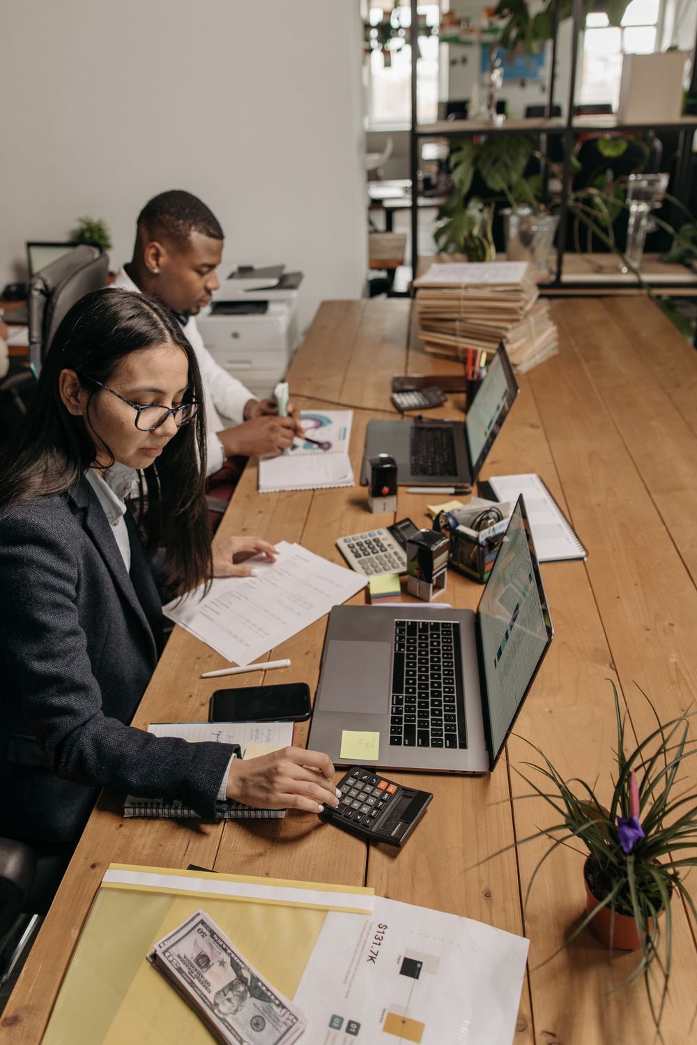 An accounts team checking documents alongside their computers