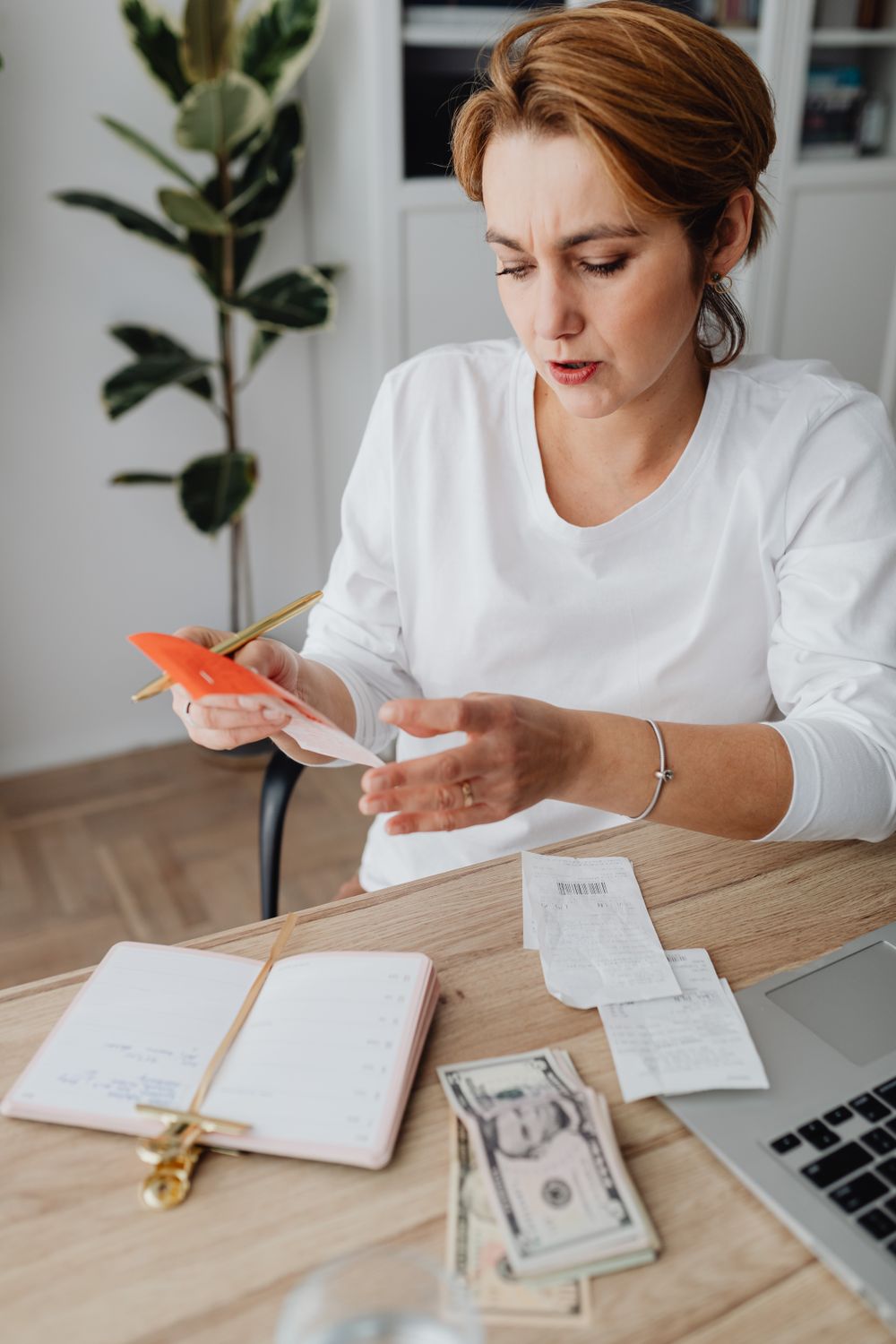A woman checking receipts and personal financial records