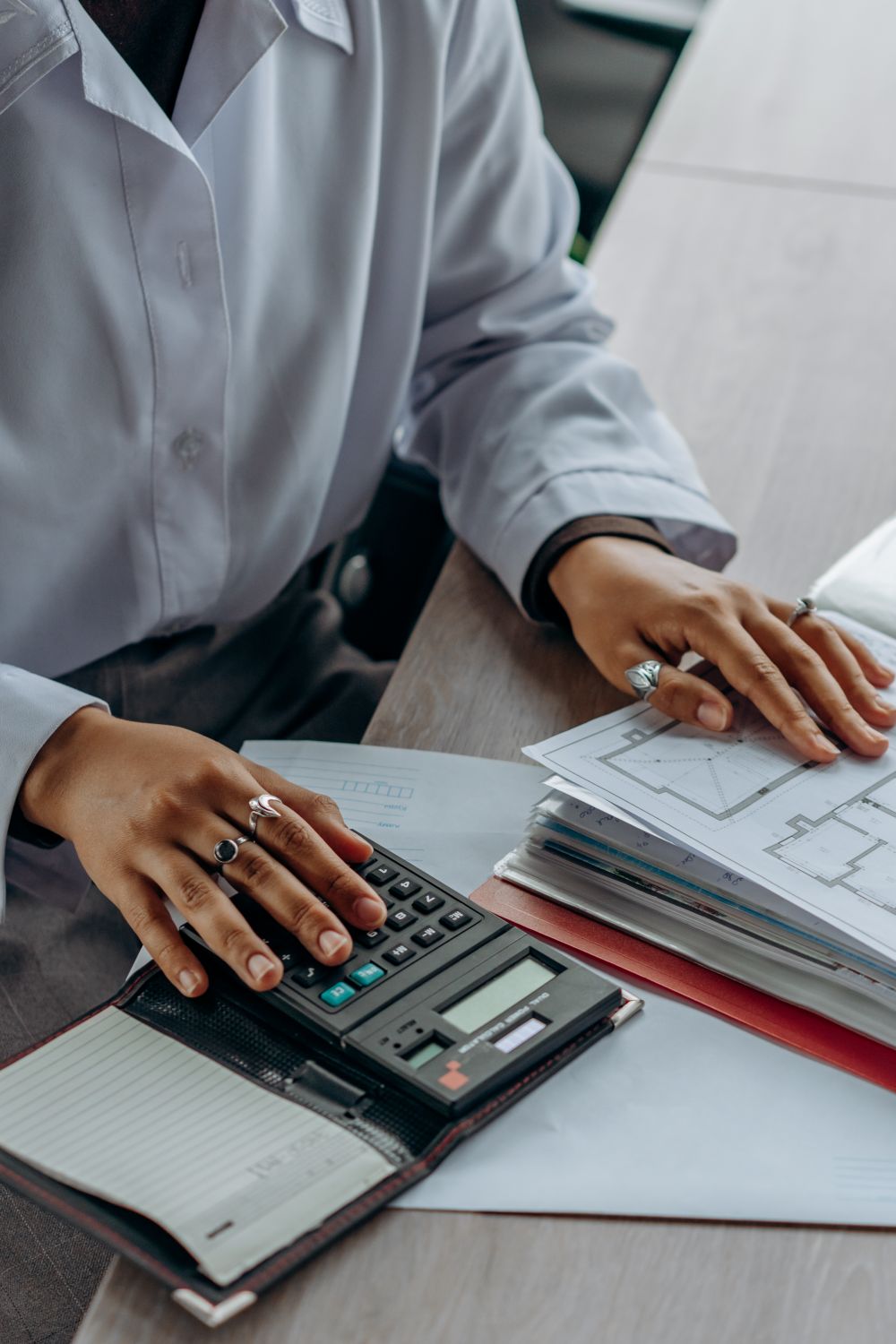 Checking financial documents and calculations at a desk